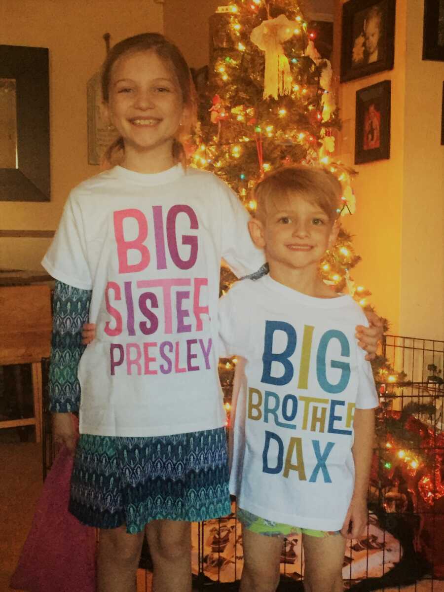 brother and sister wearing shirts to represent that they will soon be older siblings