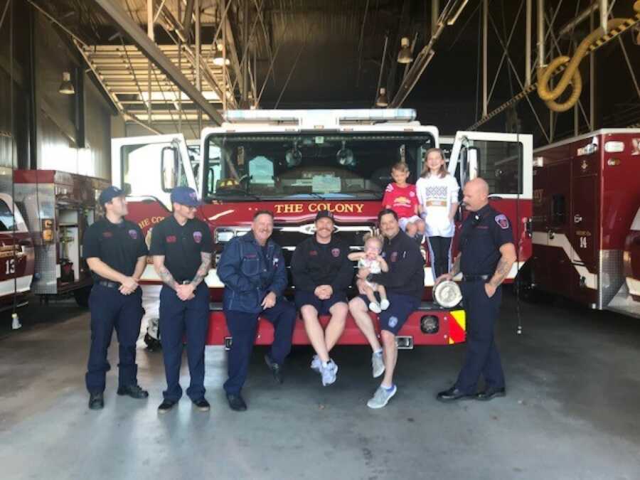 family in a fire house with fire fighters