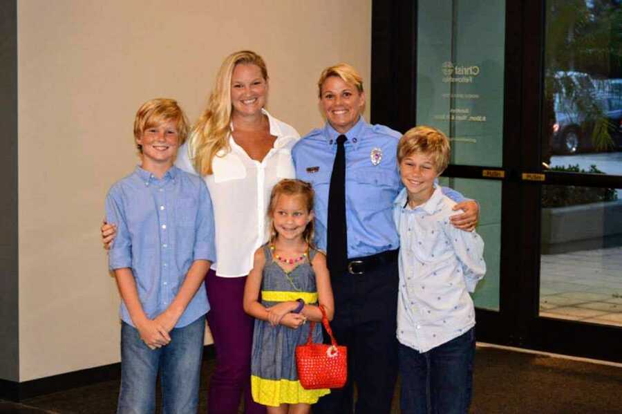 married LGBT couple pose with their three kids. 