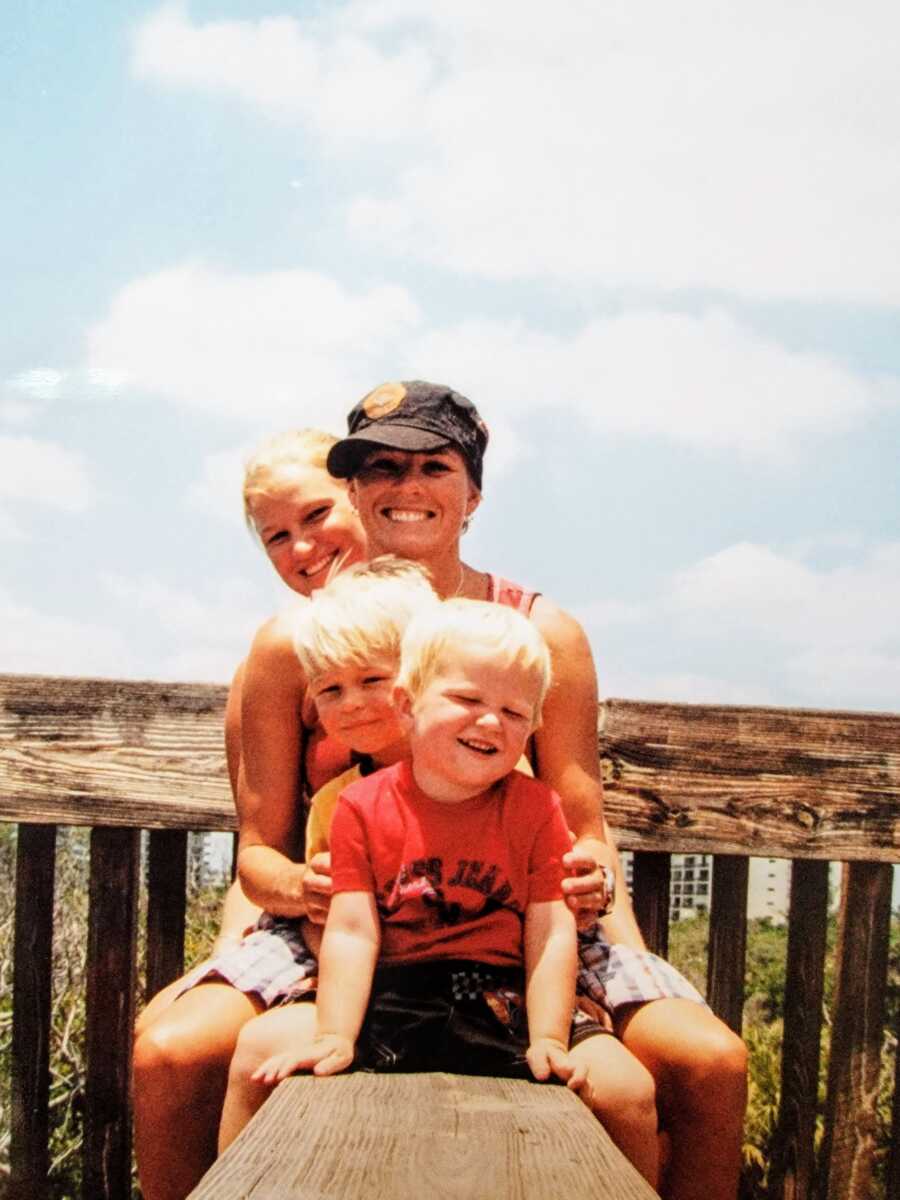 LGTB woman posing with her two sons and her girlfriend 