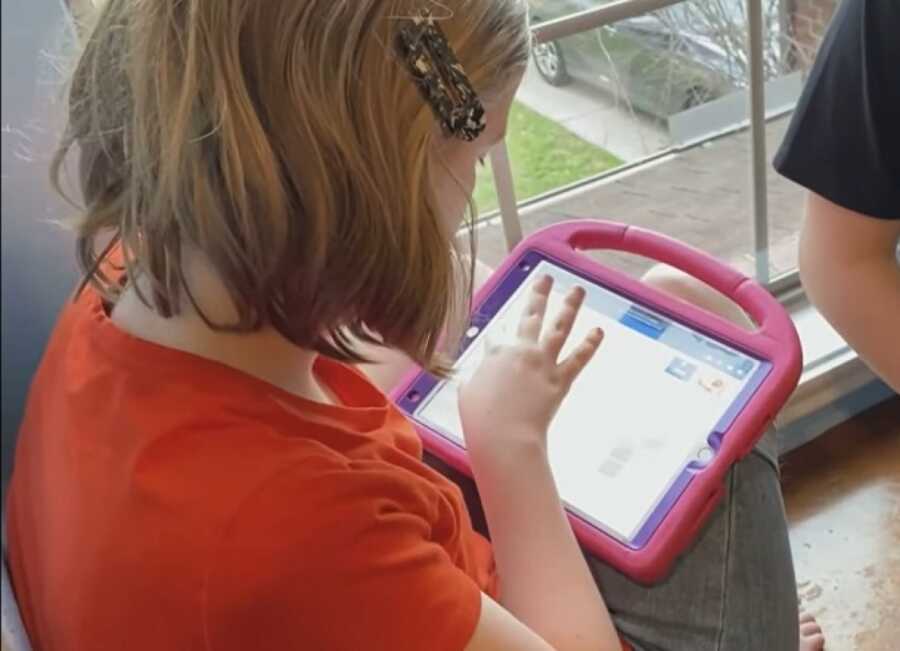 girl who is nonverbal using app her brother created for her on her ipad