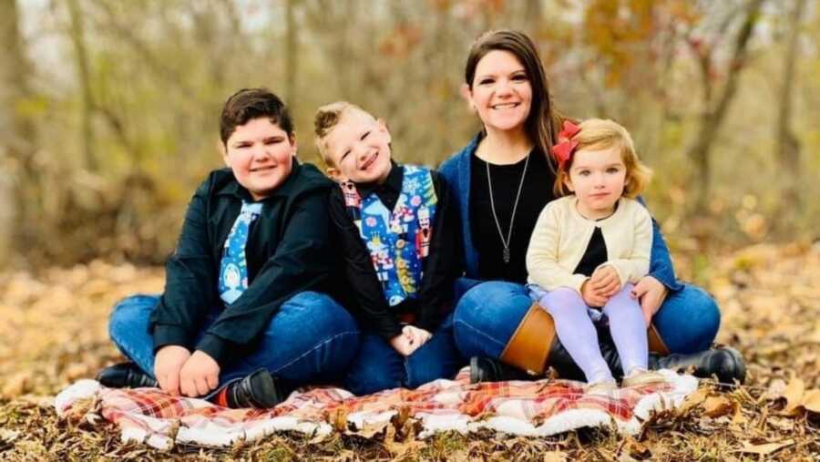 family photo surrounded by leaves in the autumn