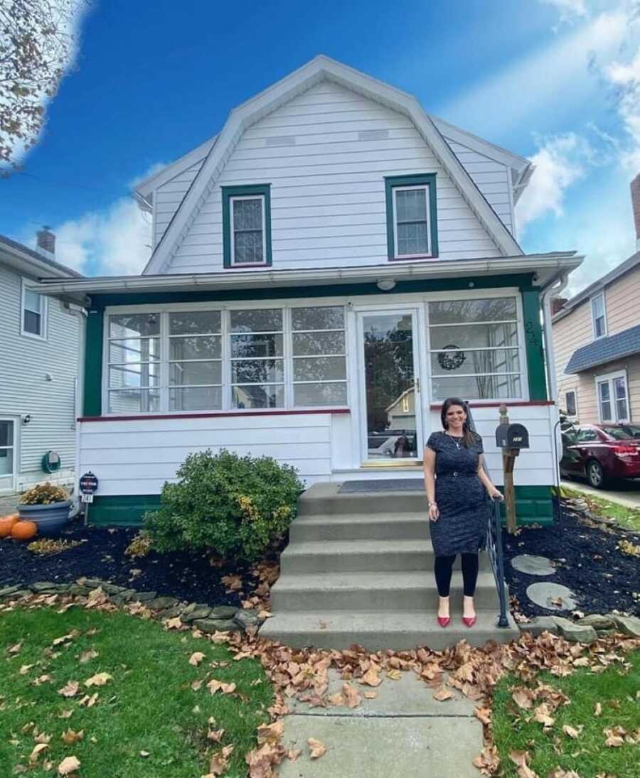 woman standing in front of a house she bought