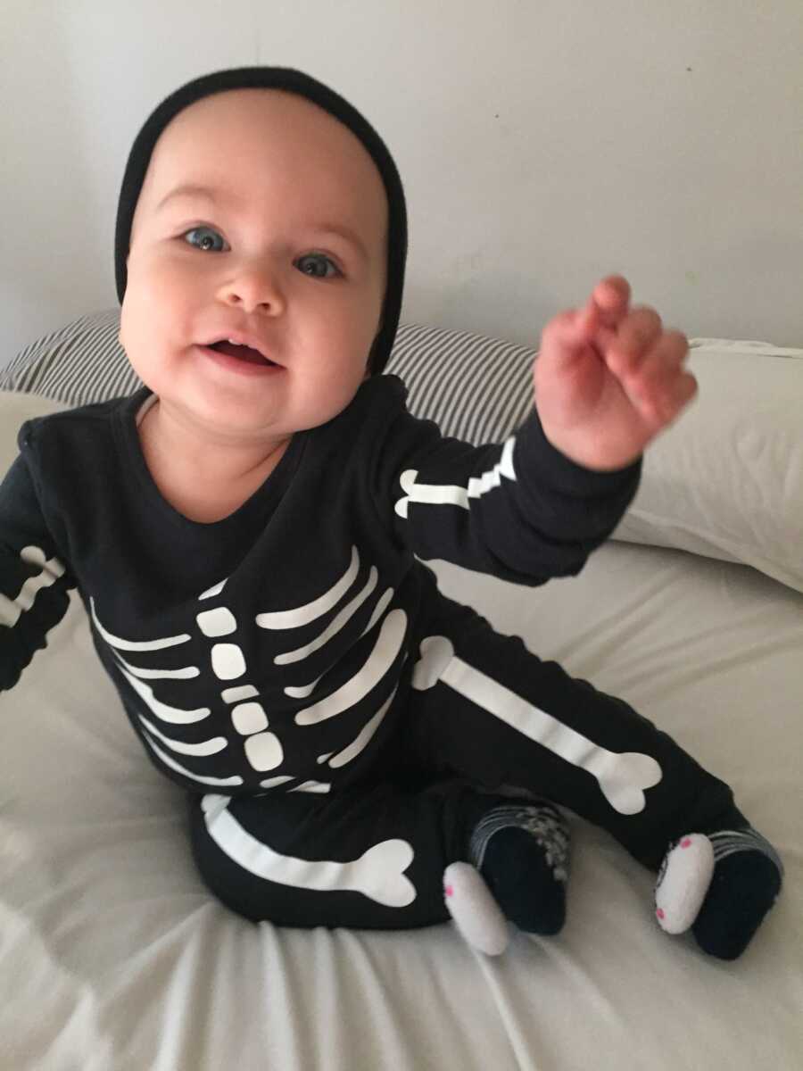 baby girl dressed up as a Skelton for halloween