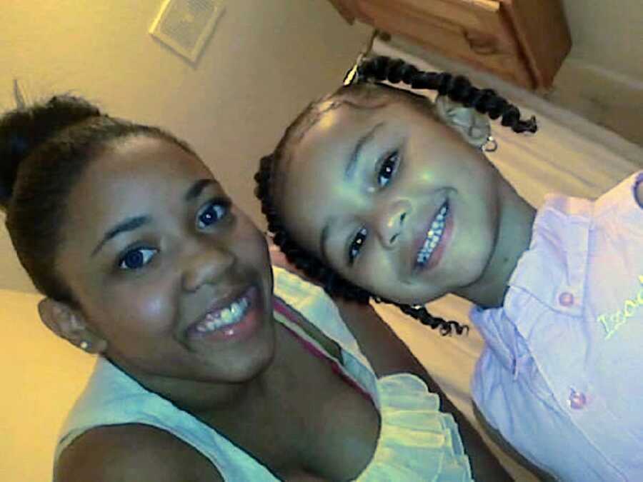 African American mom and daughter smile 