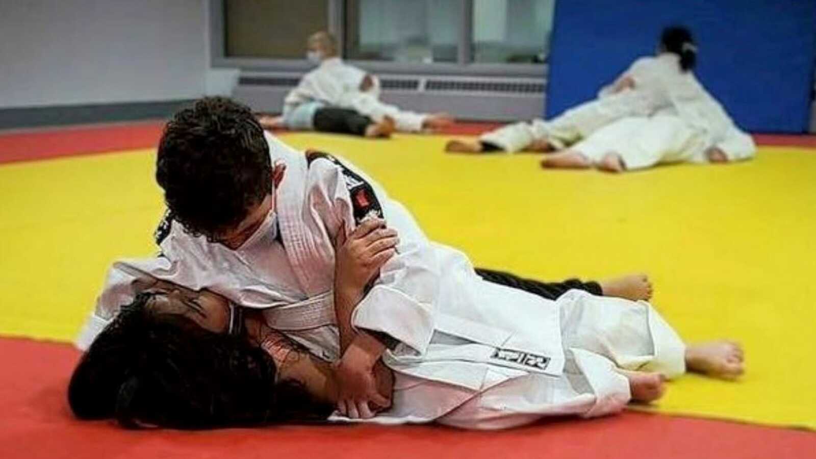 Mom takes a photo of her son practicing judo