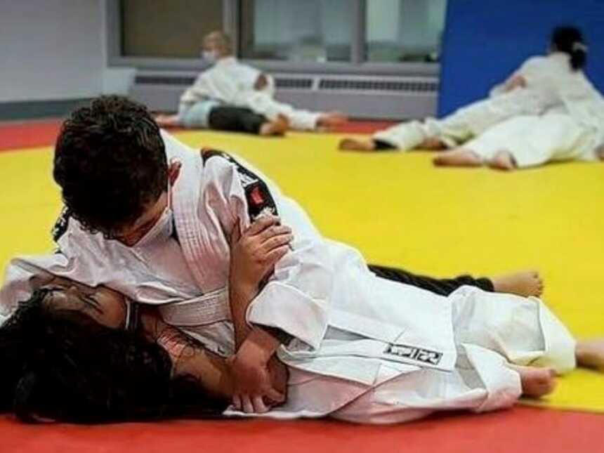 Mom takes a photo of her son practicing judo