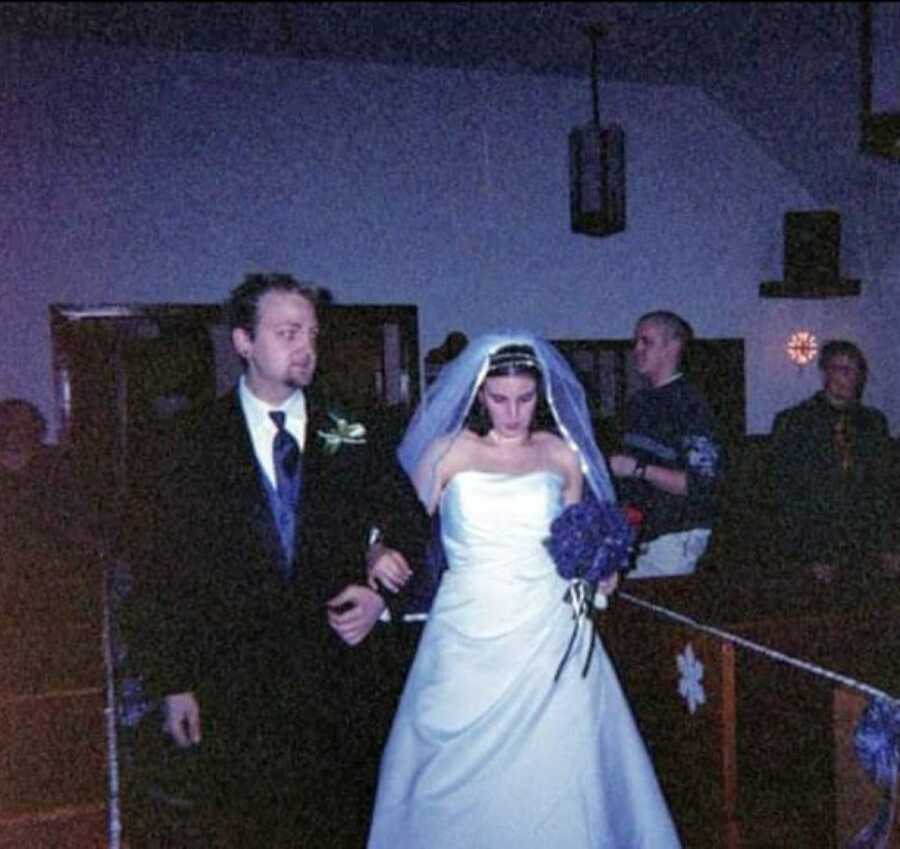 Young woman gets married to the father of her son while holding a purple bouquet of flowers