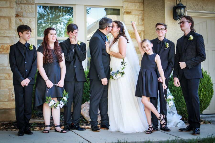 Beautiful blended family take photos together on the day of their wedding and union