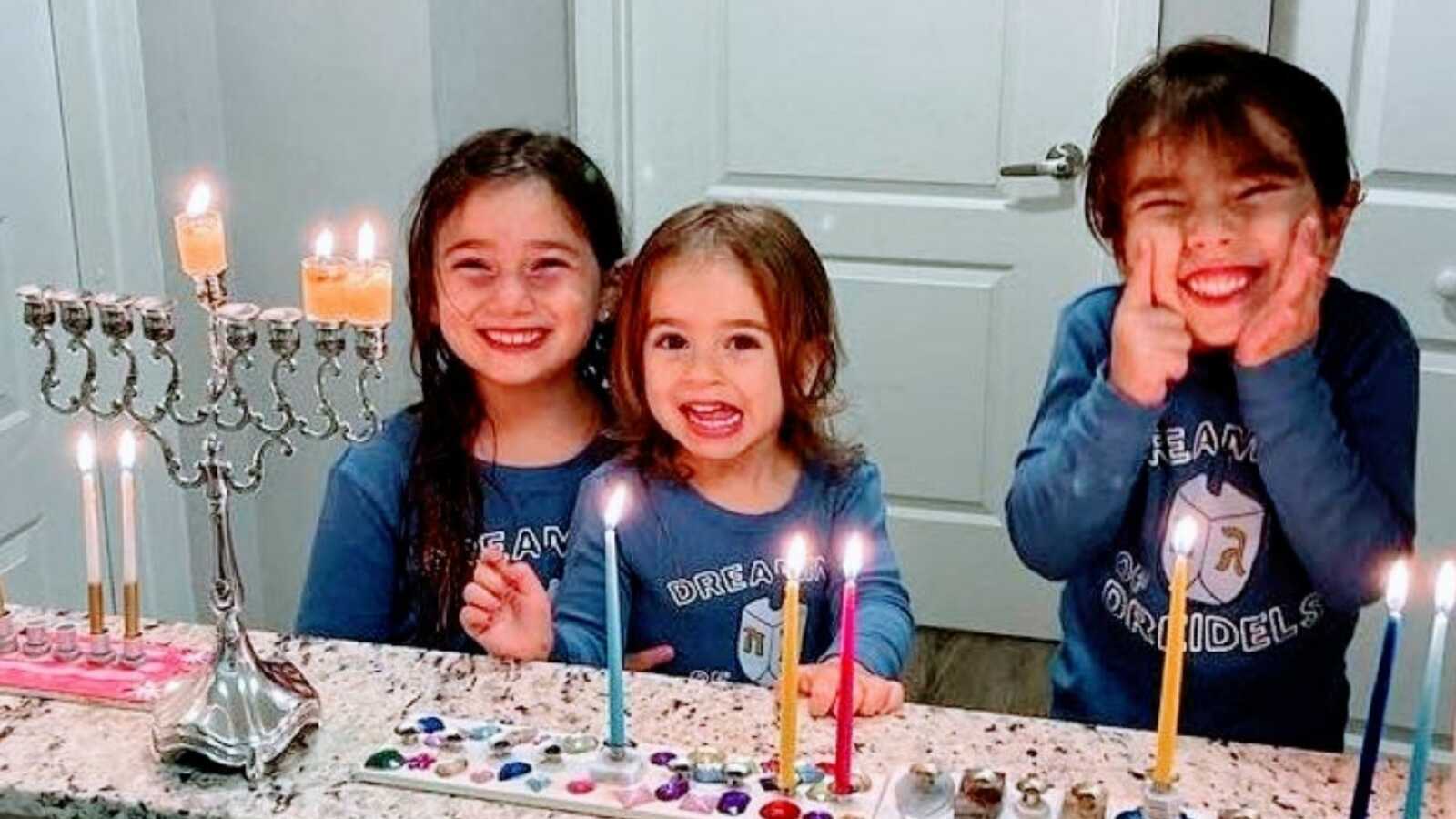 Mom shares sweet photo of her three daughters smiling hard during Hanukkah celebration