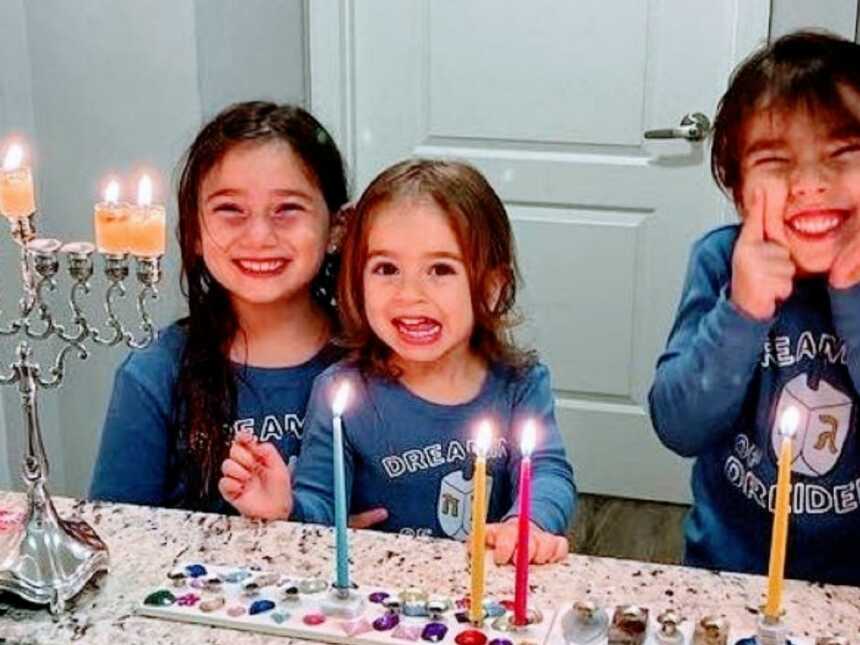 Mom shares sweet photo of her three daughters smiling hard during Hanukkah celebration