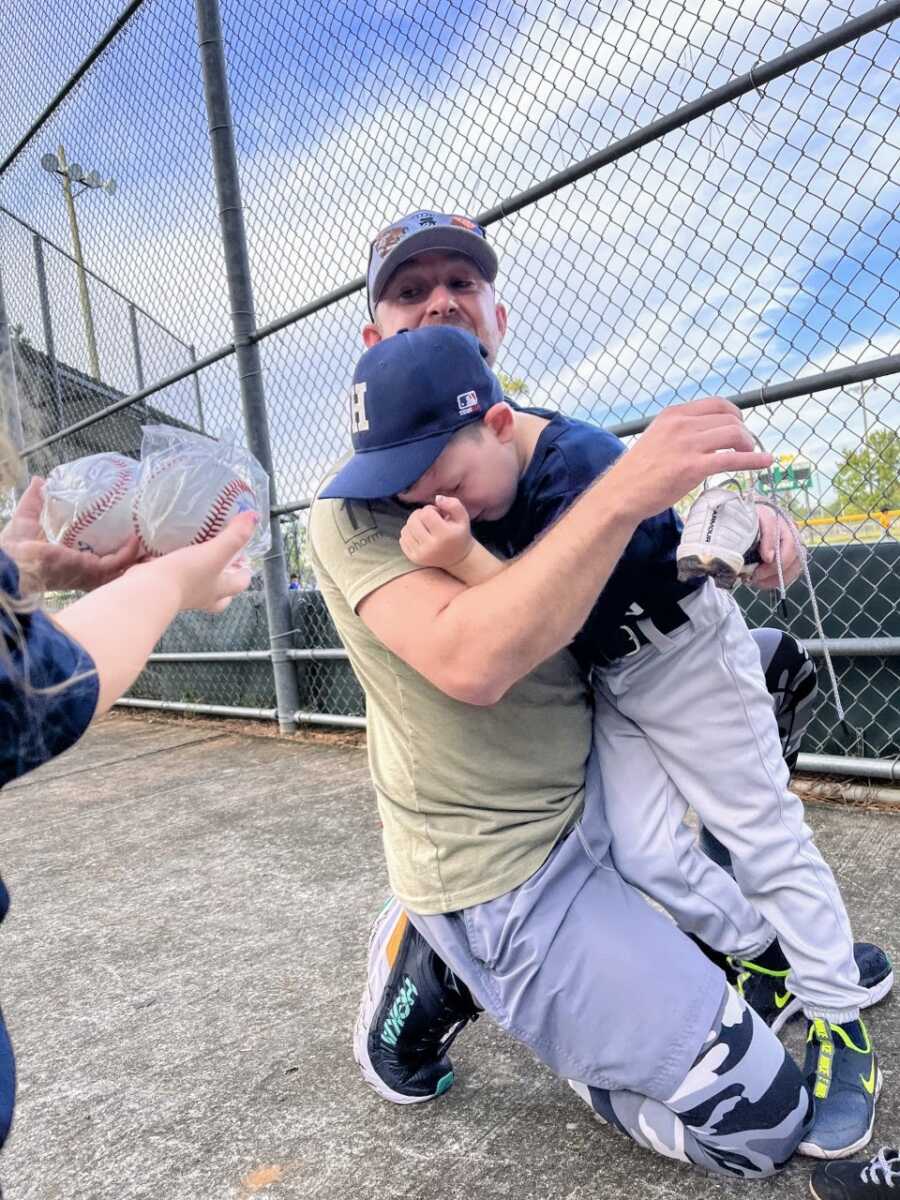 Little boy cries from excitement that his dad and t-ball coach made it to his game