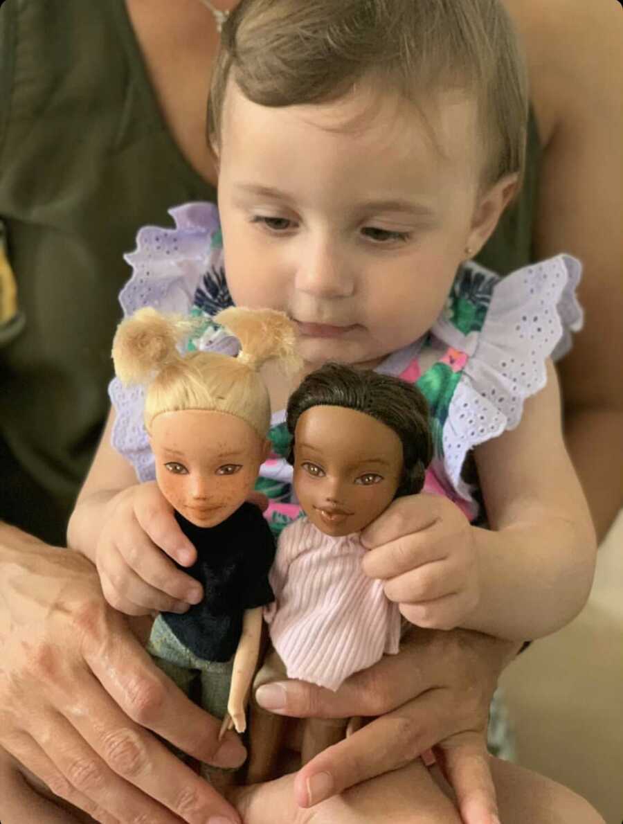 little girl playing with her dolls to show that all differences are beautiful