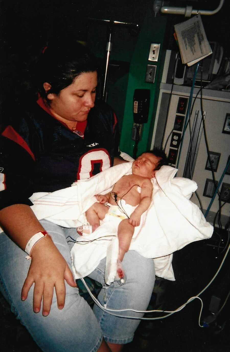First time mom holds her newborn baby daughter in the hospital