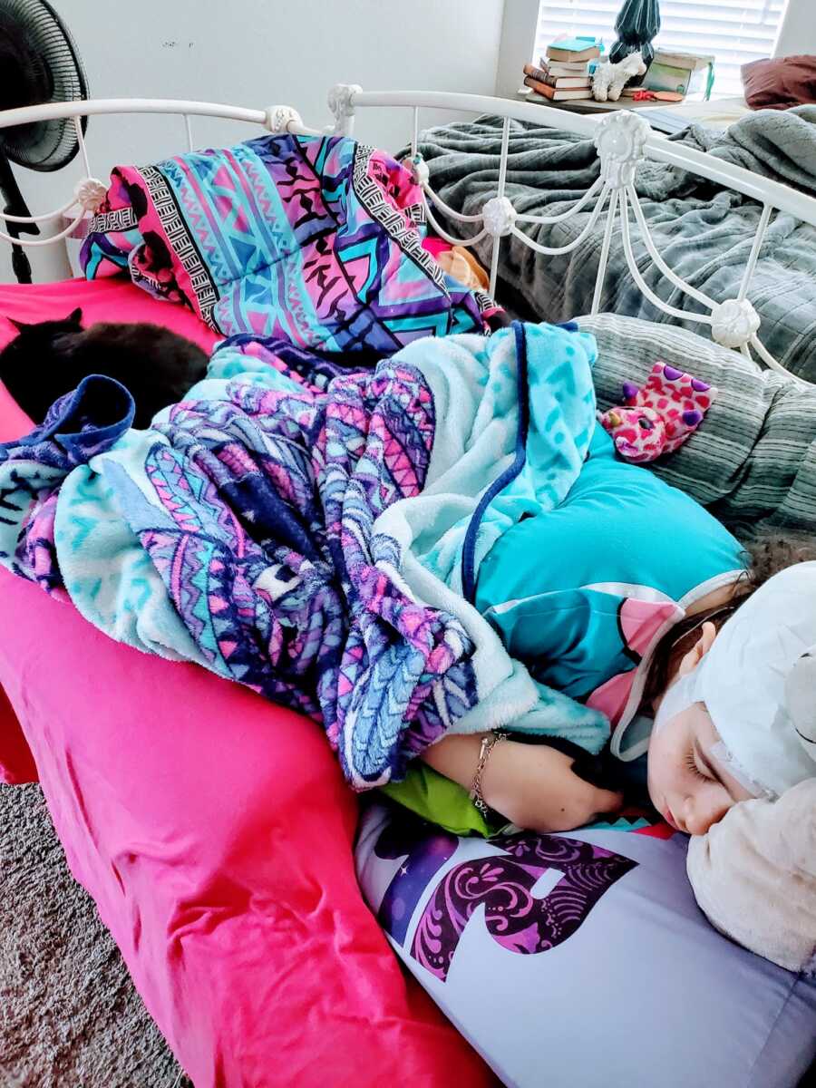 Young girl with tonic clonic seizures lays down in bed during an at home EEG