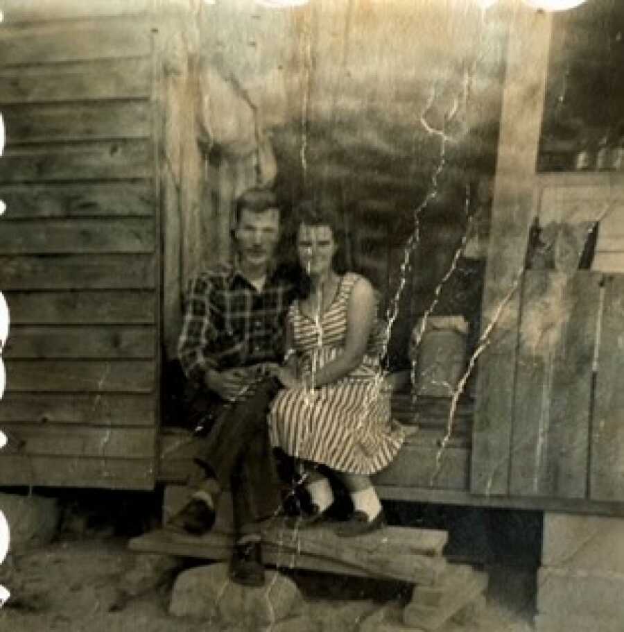 couple sitting on the stoop of their new home