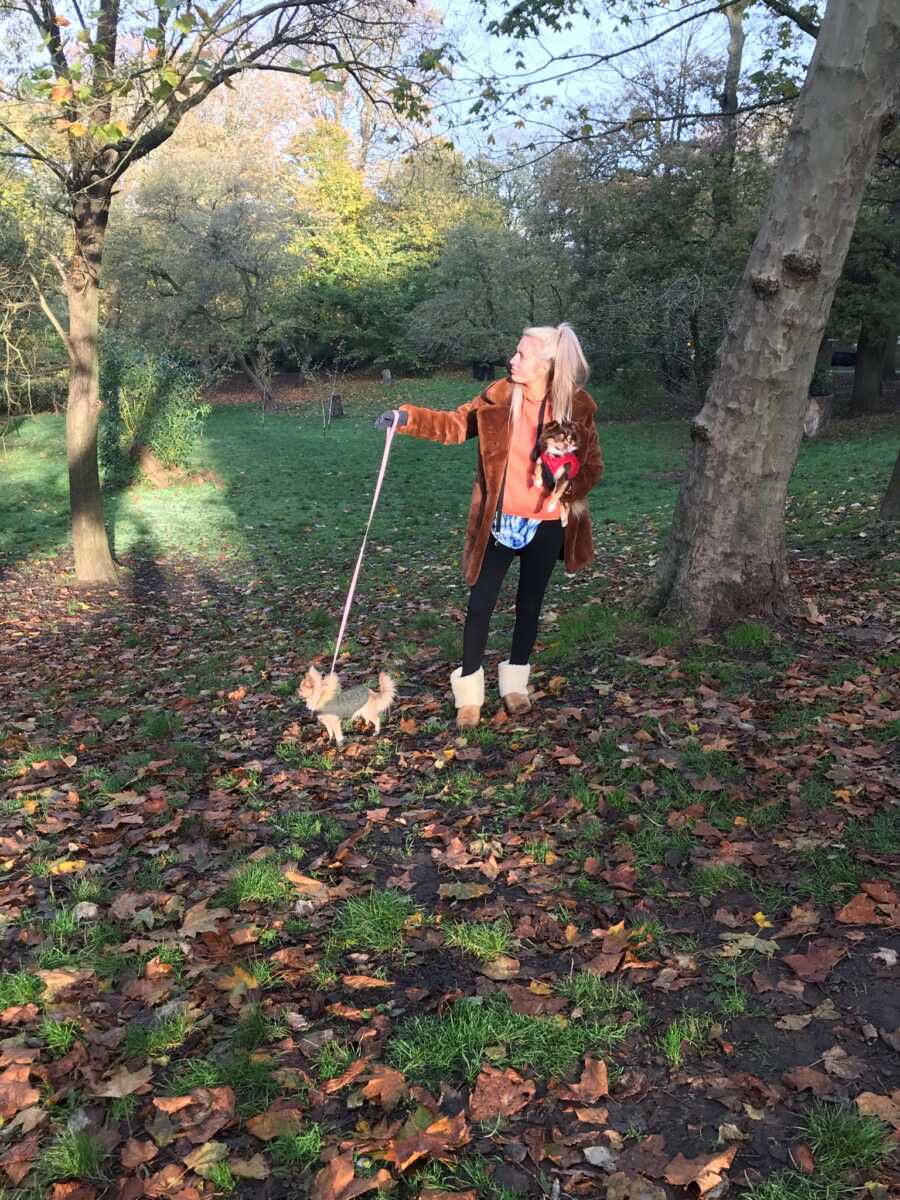 woman on a walk with her dog in the forest