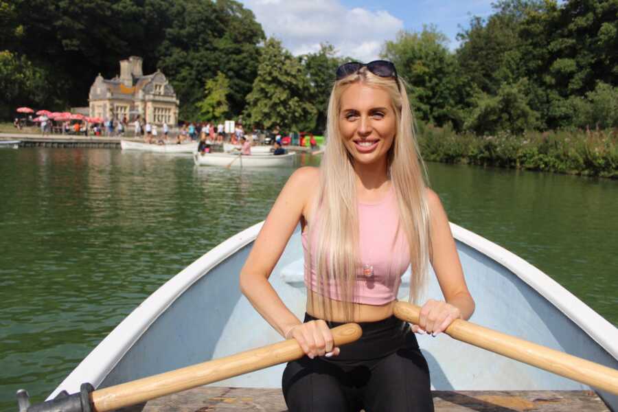 woman rowing a boat in the sunlight