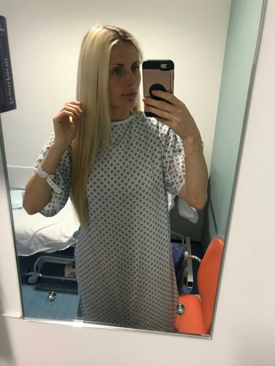 woman in hospital in a gown waiting for her surgery