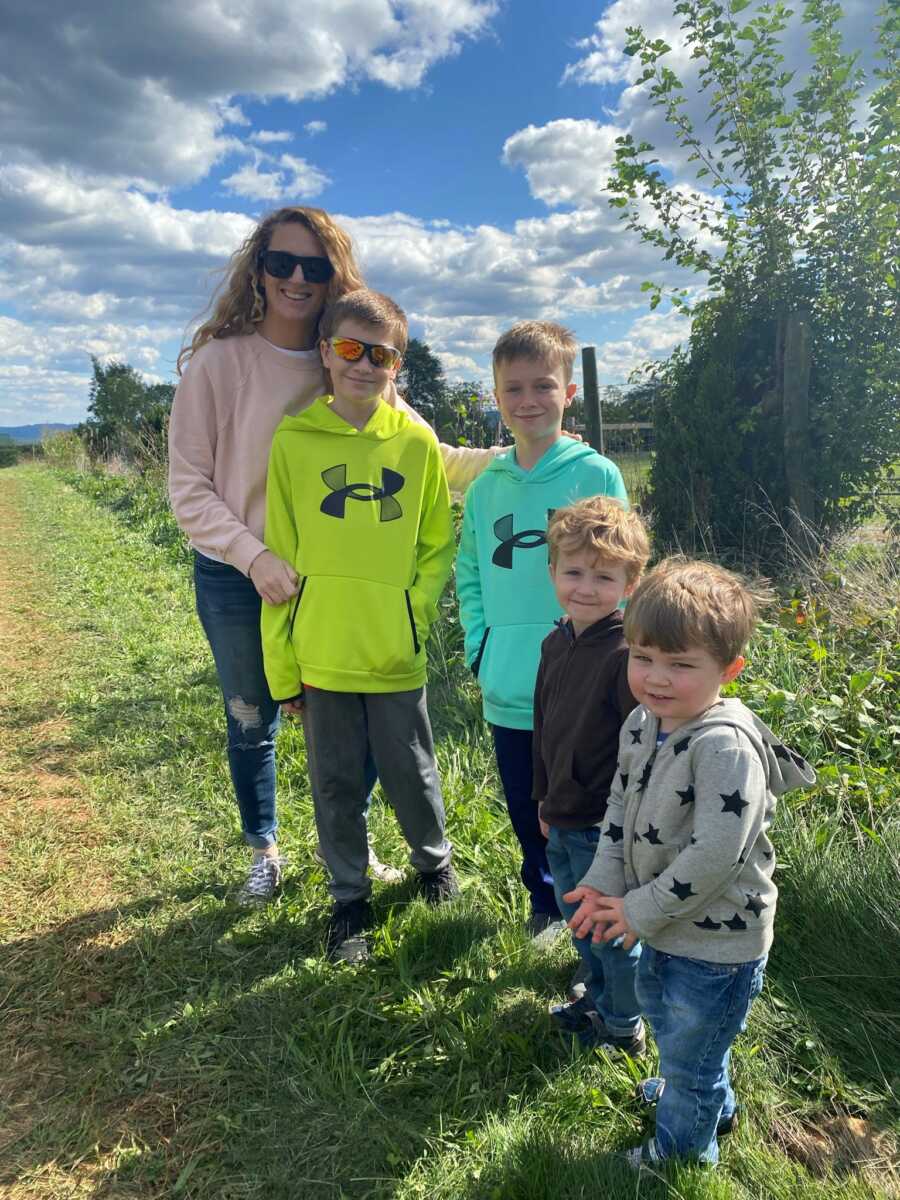 mom with her four sons in a field after her accident