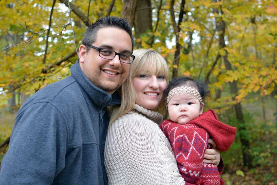 The Banion's smile for a family picture with their new baby.