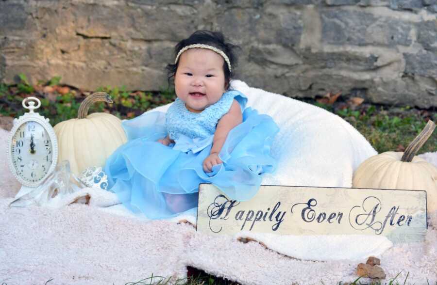The Banion's baby girl smiles for a Happily Ever After photoshoot. 