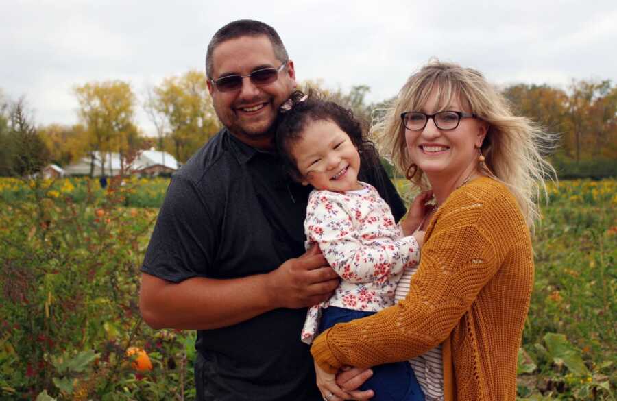 The Banion's smile for a family picture with their adopted daughter. 