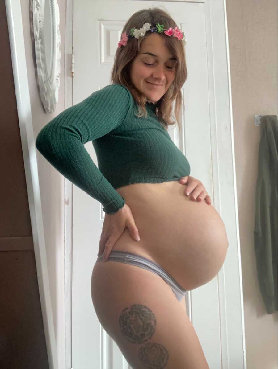 mom showing off her baby belly about to pop