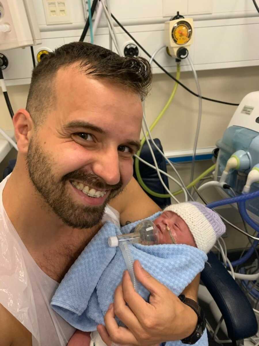 dad holding baby after she was born