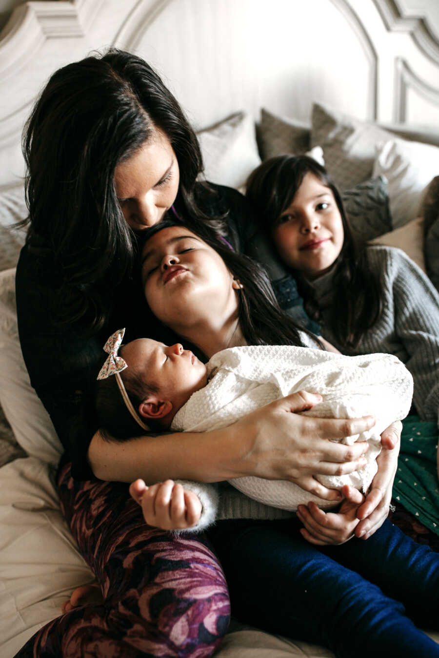 Mom and daughters take family pictures. 