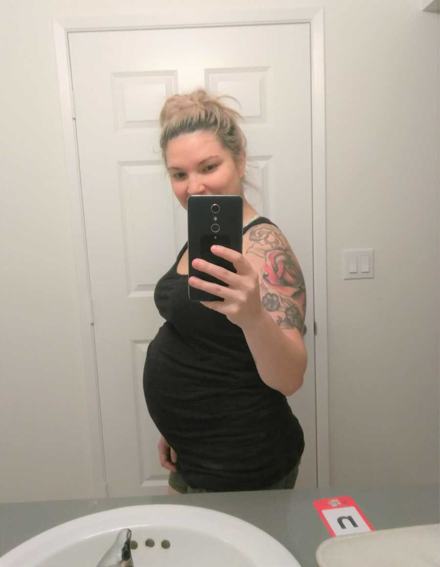 Breinne takes a picture of her baby bump at 8 months pregnant.