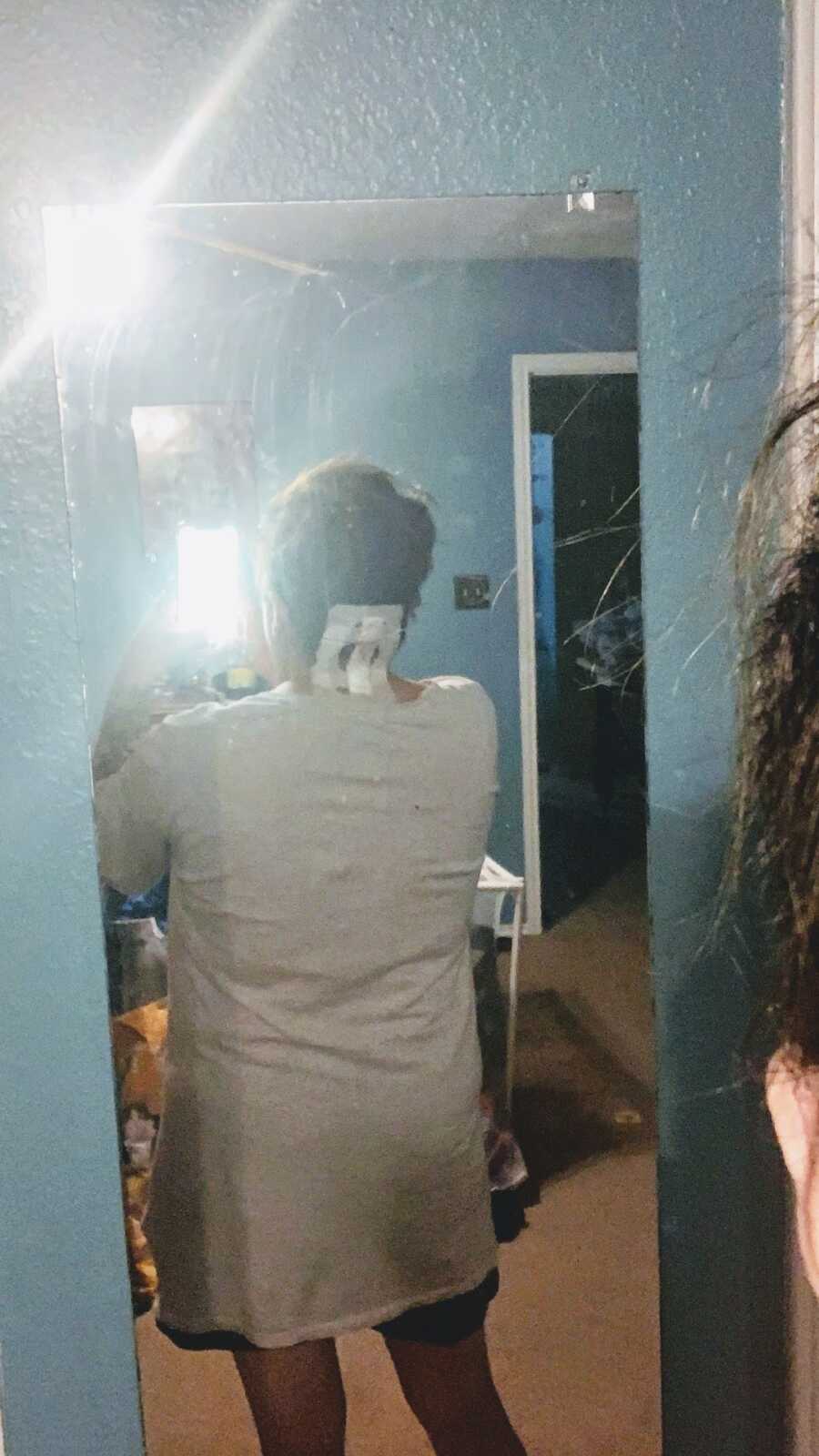Woman takes mirror selfie post surgery