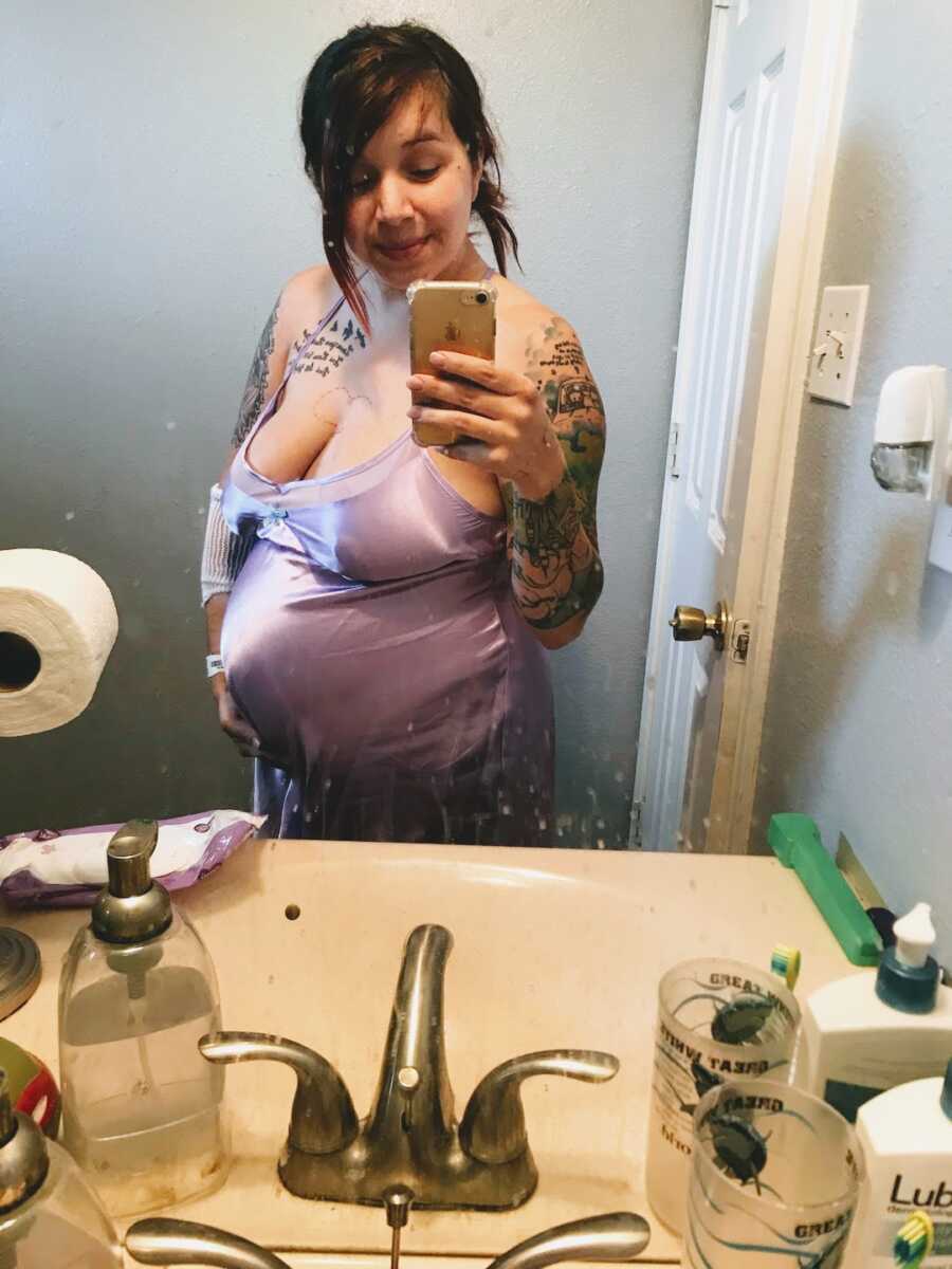 mom taking selfie in bathroom while pregnant