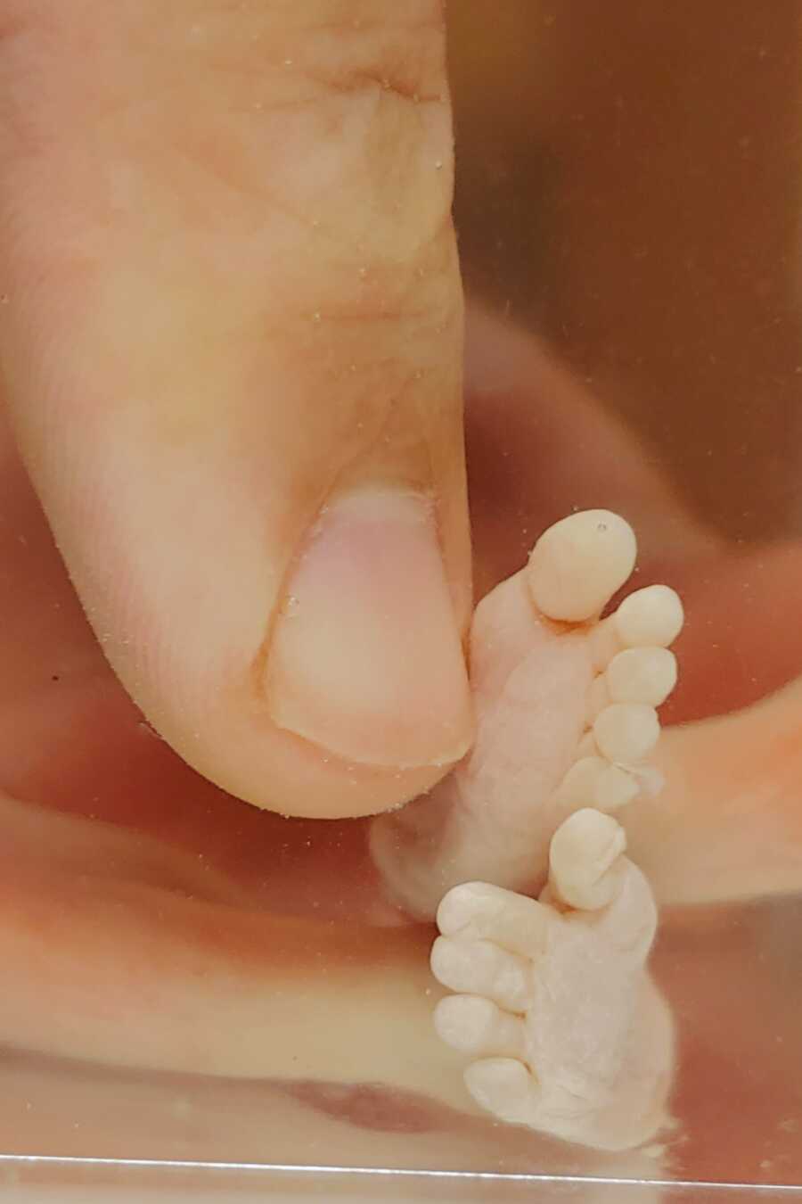 mom holding daughter's foot