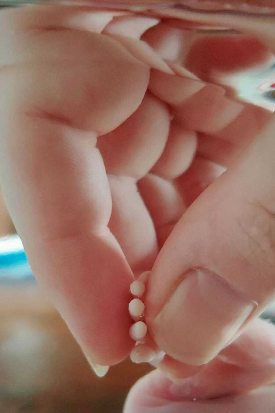 mom holding the hand of her daugher