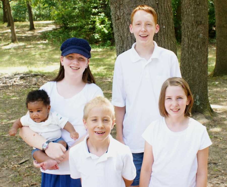 Emma and her siblings take a group picture. 