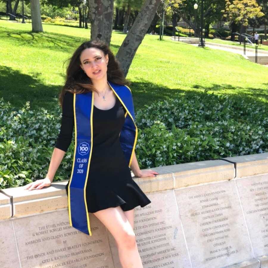 Woman graduating college wearing black dress