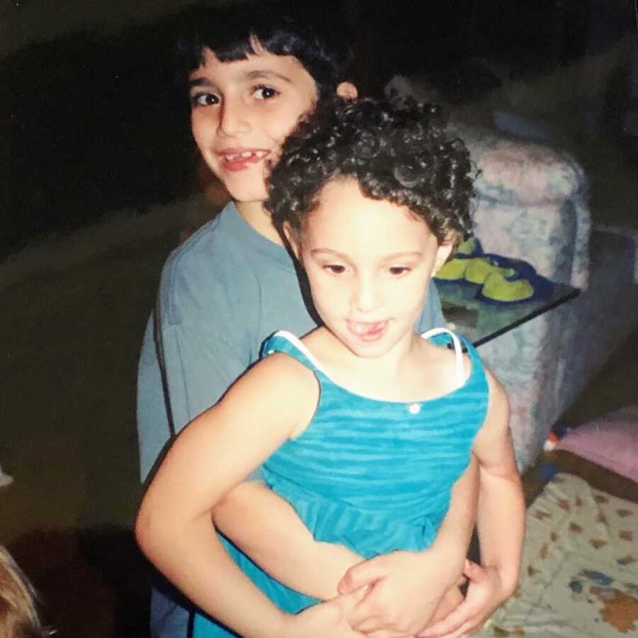 Woman and her brother together at a young age