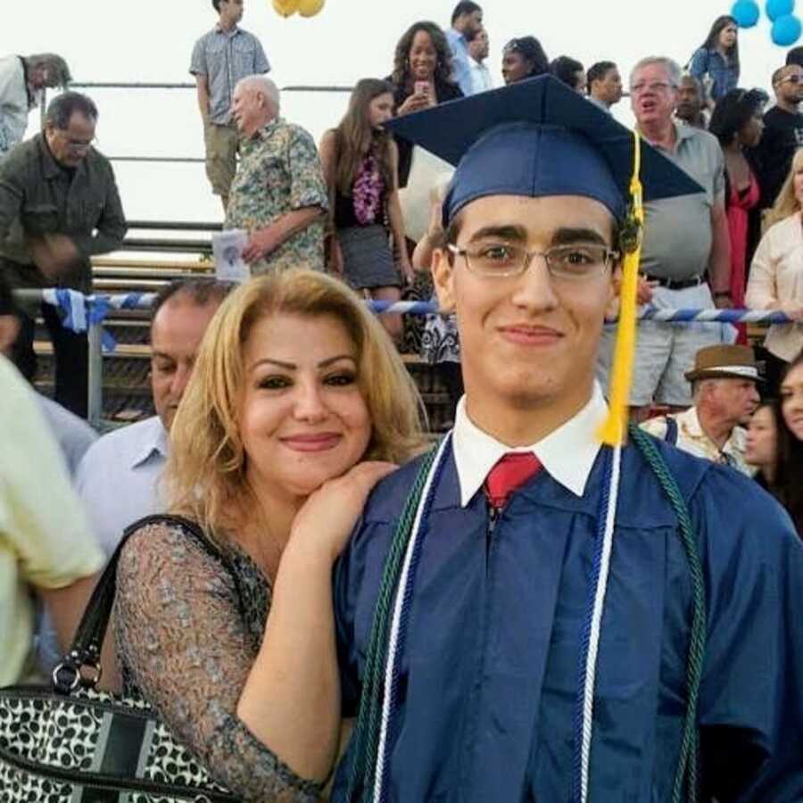 Man wearing cap and gown with his mother