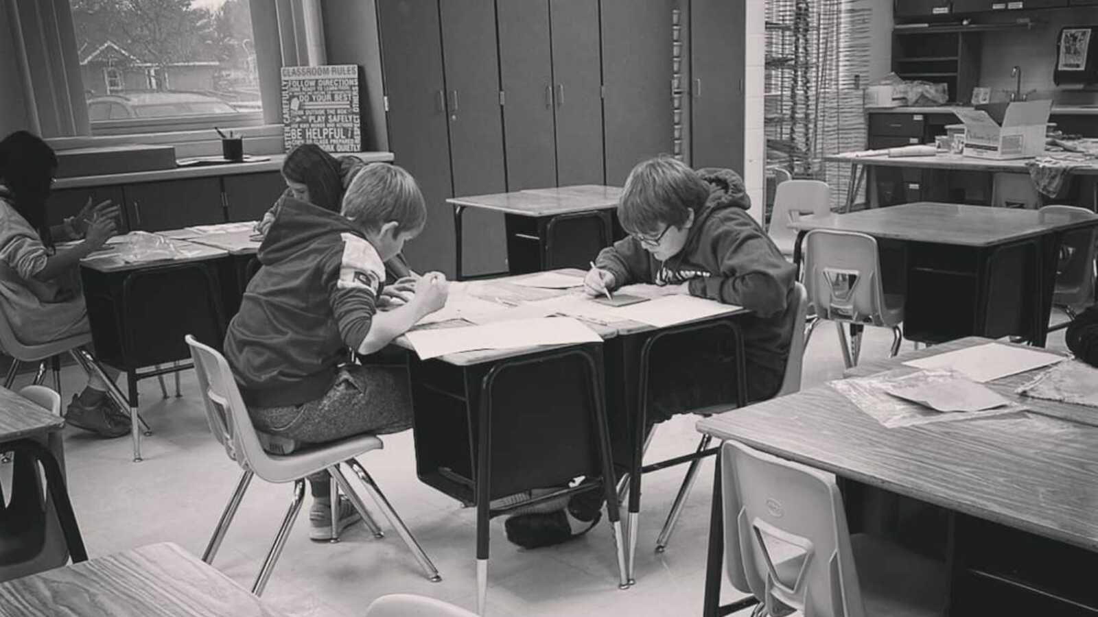 kids sitting at desks working on their school activities