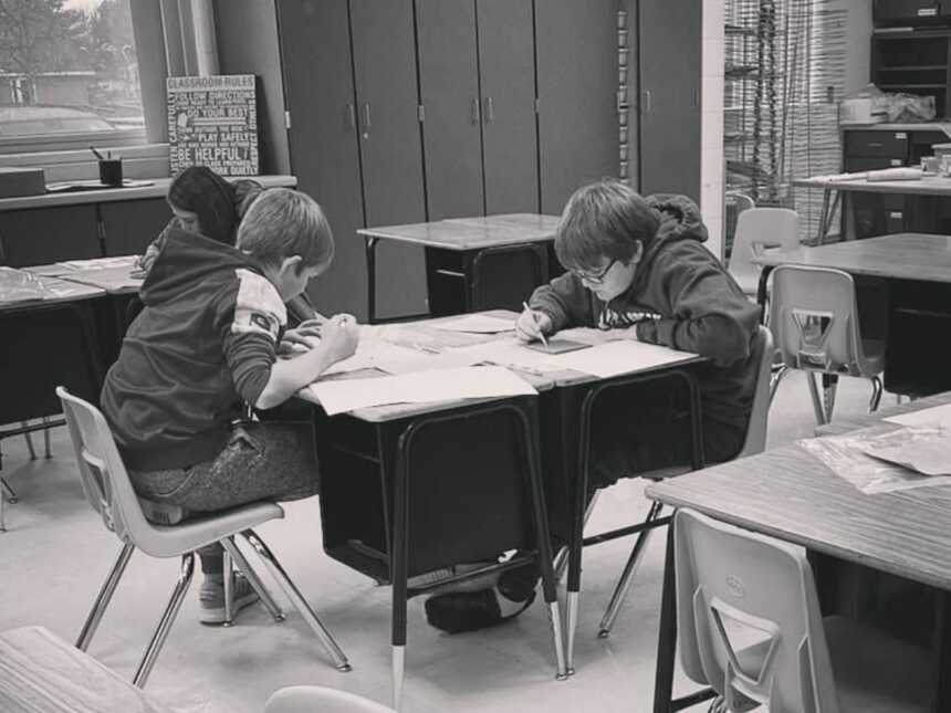 kids sitting at desks working on their school activities