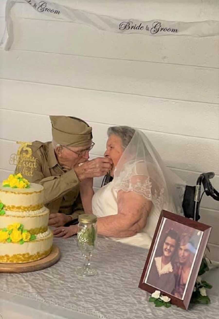 Great-grandparents feed each other wedding cake. 