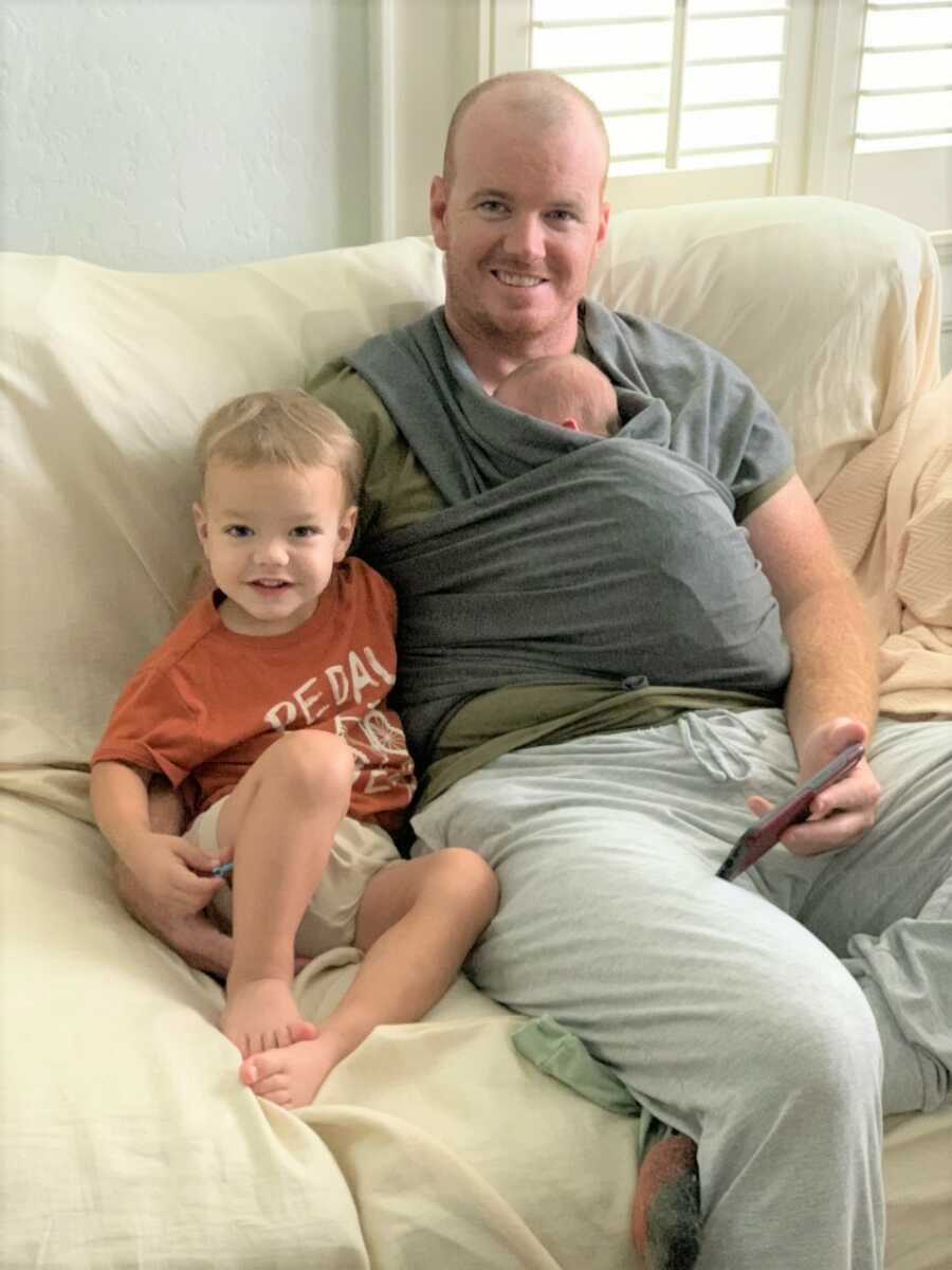 Dad and boys sit together on the couch. 