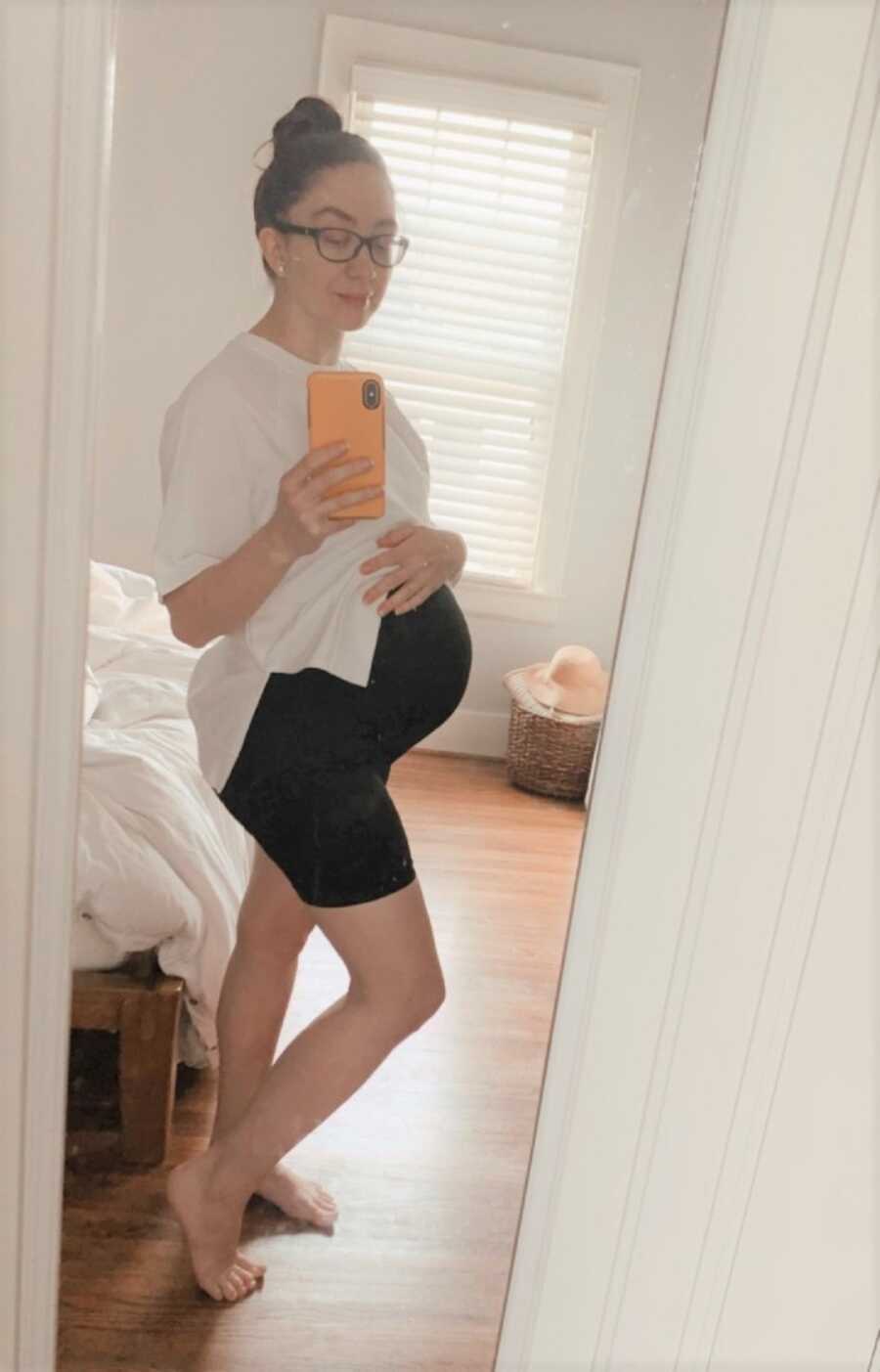 Jaclyn takes a baby bump picture at seven months pregnant.