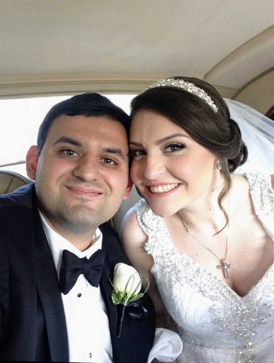 Bride and groom on their wedding day in a car