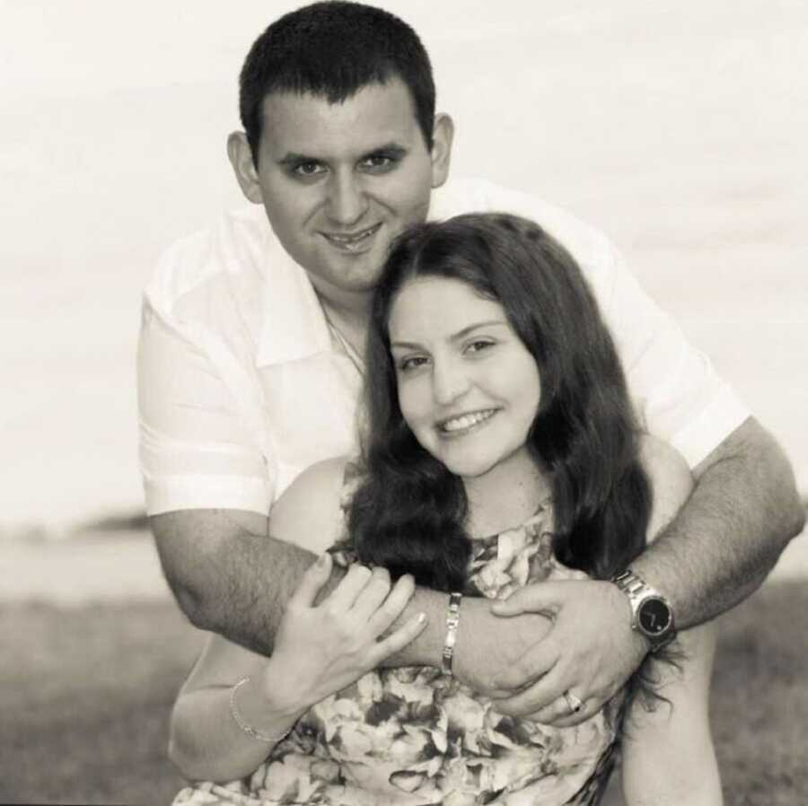 A woman with CF and her husband on a beach