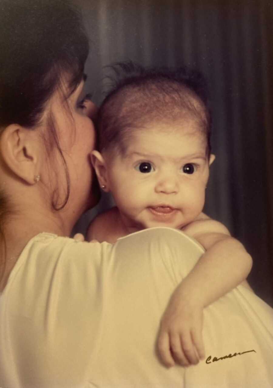 baby with Cystic Fibrosis being held by her mother