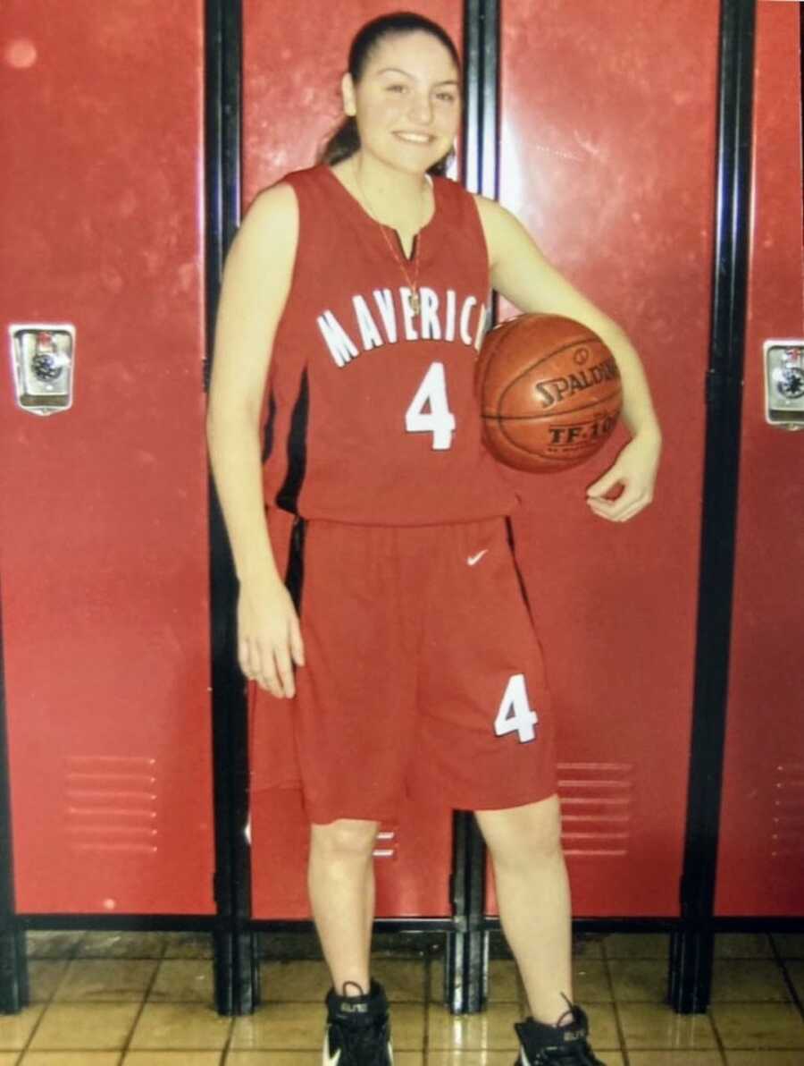 Woman in a jersey holding a basketball