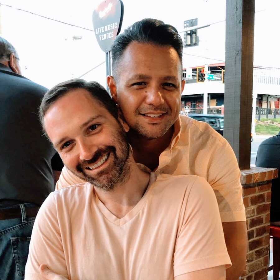 Gay men wearing matching colored shirts at a restaurant