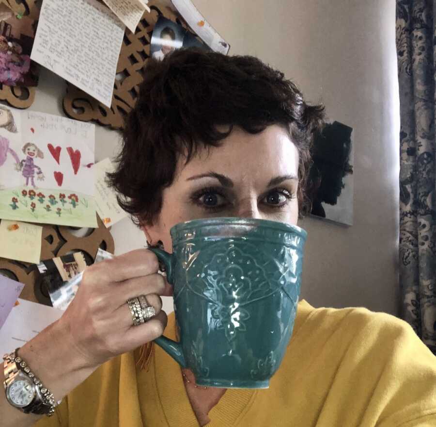 middle-aged mom drinking out of a mug